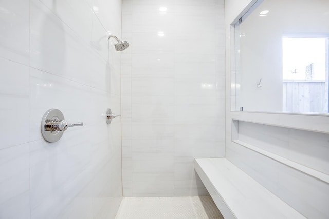 bathroom with a tile shower