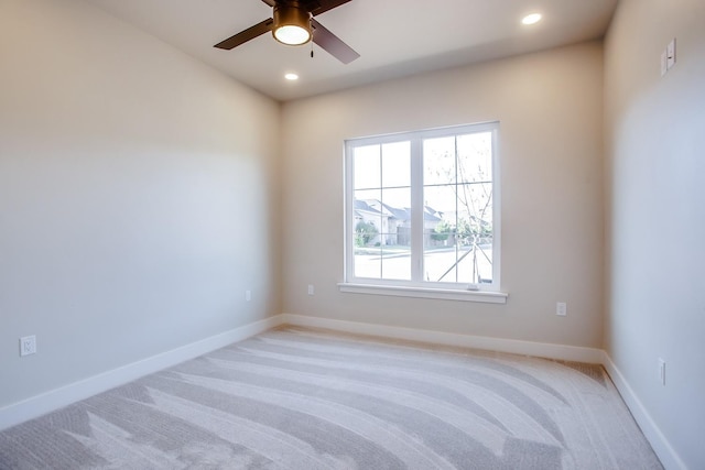 empty room with light colored carpet and ceiling fan