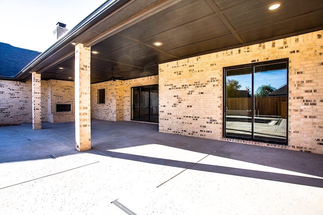 view of patio with a fireplace