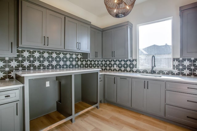 kitchen featuring sink, gray cabinetry, and light hardwood / wood-style flooring