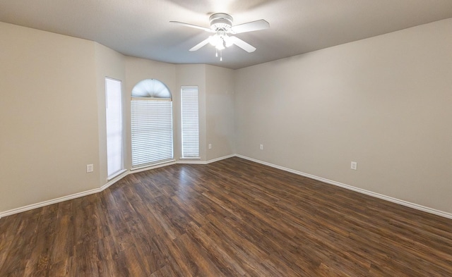 unfurnished room with dark wood-type flooring and ceiling fan