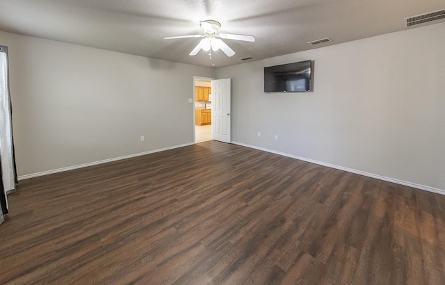 empty room featuring ceiling fan and dark hardwood / wood-style flooring