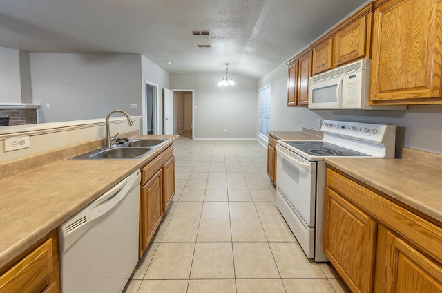 kitchen with lofted ceiling, sink, hanging light fixtures, a notable chandelier, and white appliances