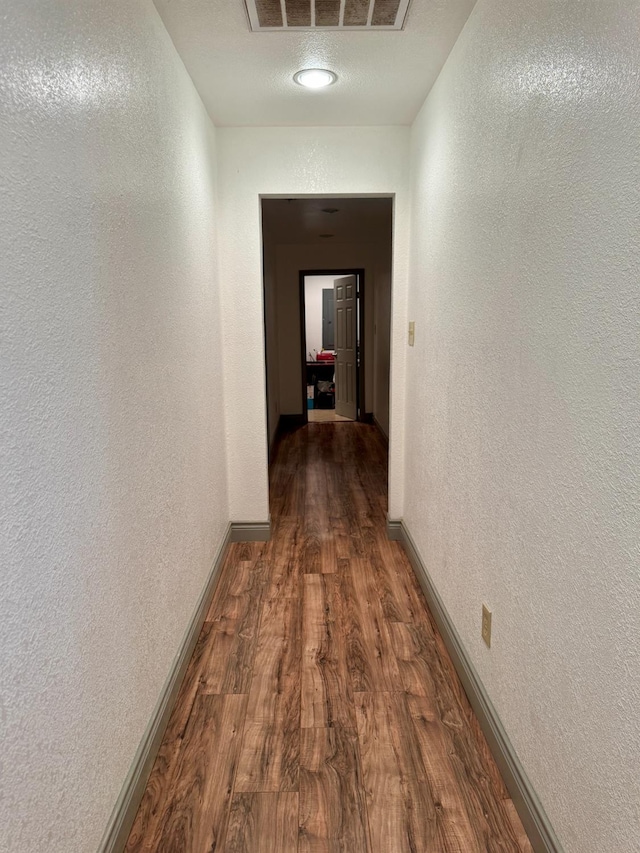 corridor featuring hardwood / wood-style floors