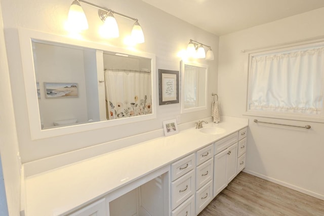 bathroom featuring vanity, toilet, and wood-type flooring