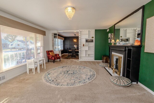 sitting room with an inviting chandelier and carpet flooring