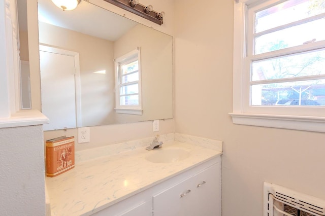 bathroom with vanity and heating unit