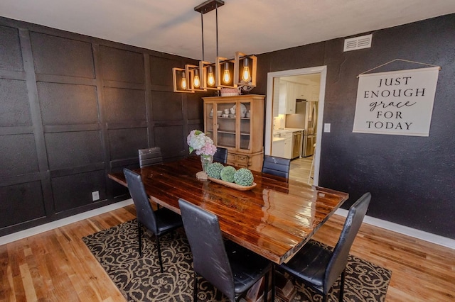 dining space with light wood-type flooring