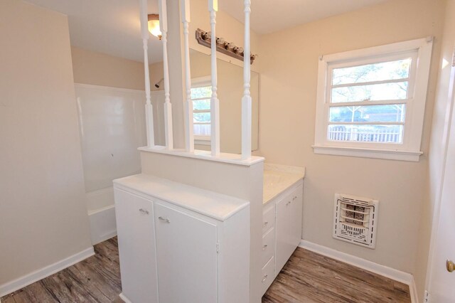 bathroom featuring hardwood / wood-style floors and heating unit