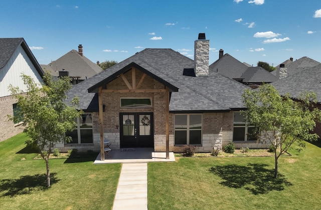 view of front of house featuring a front yard and french doors