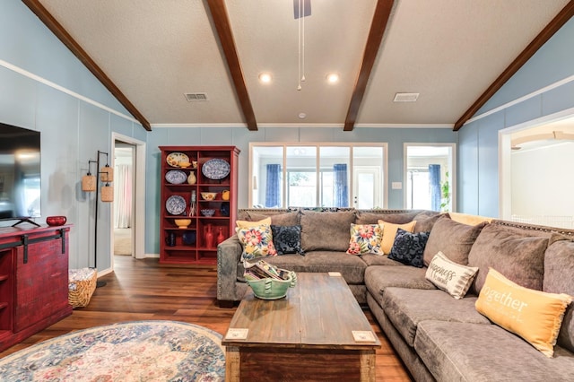 living room featuring lofted ceiling with beams, ornamental molding, and dark wood-type flooring