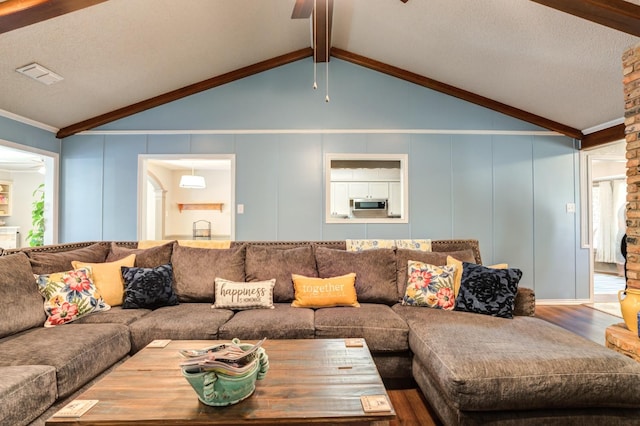 living room featuring hardwood / wood-style flooring, lofted ceiling with beams, and ceiling fan