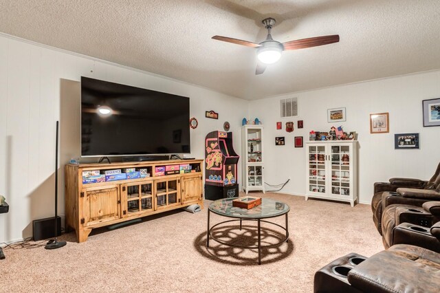 living room with ceiling fan, carpet, and a textured ceiling