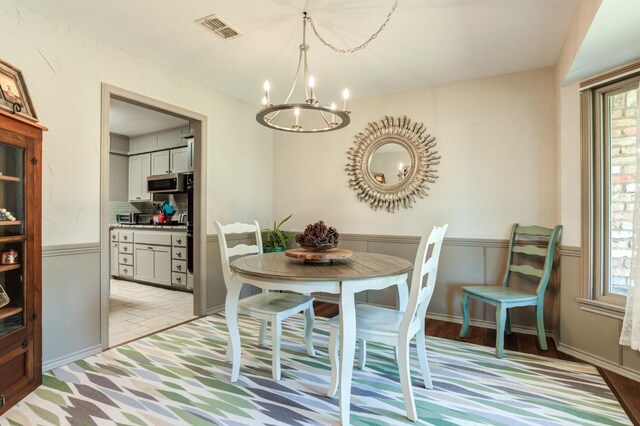 dining area with plenty of natural light and a notable chandelier