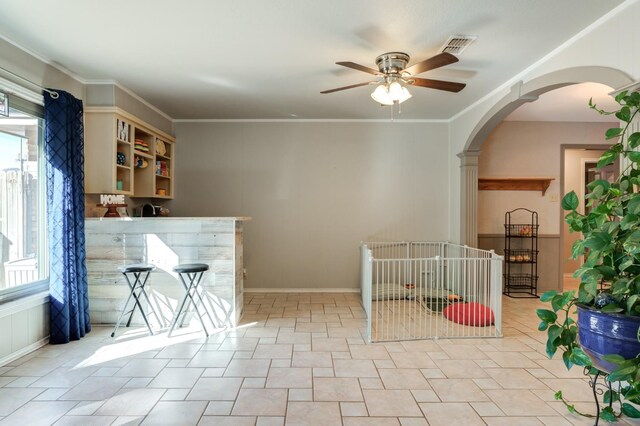 interior space featuring ceiling fan, crown molding, and a healthy amount of sunlight