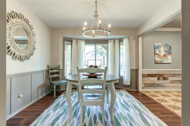 dining room with dark wood-type flooring and a chandelier