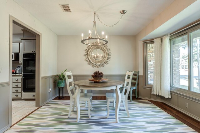 unfurnished dining area featuring an inviting chandelier