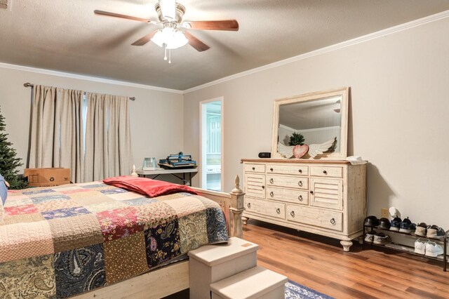 bedroom featuring crown molding, wood-type flooring, and ceiling fan