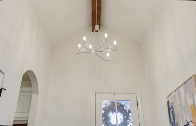 room details with beam ceiling and a notable chandelier