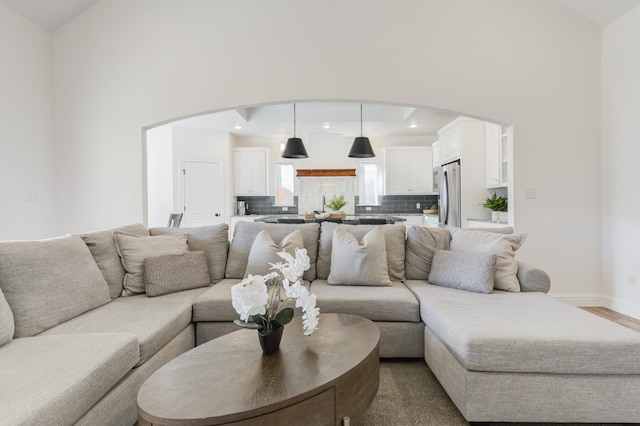 living room with hardwood / wood-style flooring and high vaulted ceiling