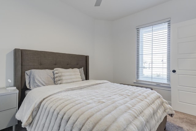 bedroom featuring ceiling fan and carpet