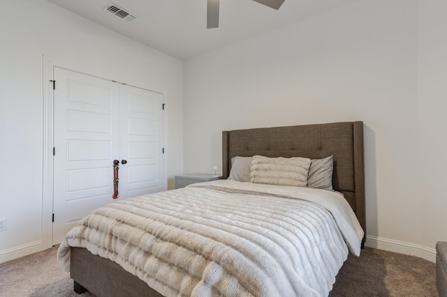 bedroom with dark carpet, a closet, and ceiling fan