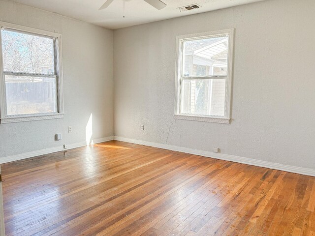 spare room with ceiling fan and wood-type flooring