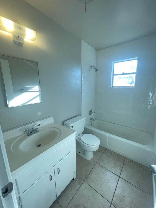 full bathroom featuring vanity, tile patterned floors, toilet, and tiled shower / bath