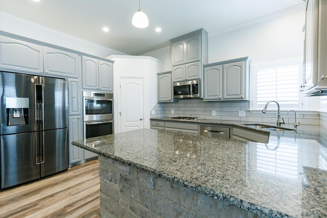 208 Berkshire Ave, Wolfforth, TX 79382 - kitchen featuring appliances with stainless steel finishes, ornamental molding, a sink, and dark stone countertops