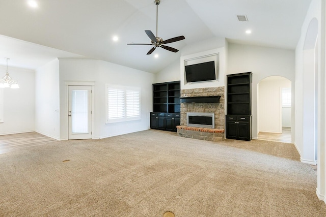 208 Berkshire Ave, Wolfforth, TX 79382 - unfurnished living room with ceiling fan, carpet floors, arched walkways, a stone fireplace, and visible vents
