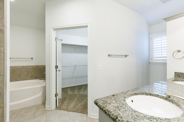 208 Berkshire Ave, Wolfforth, TX 79382 - full bath with tile patterned floors, a walk in closet, a garden tub, and vanity