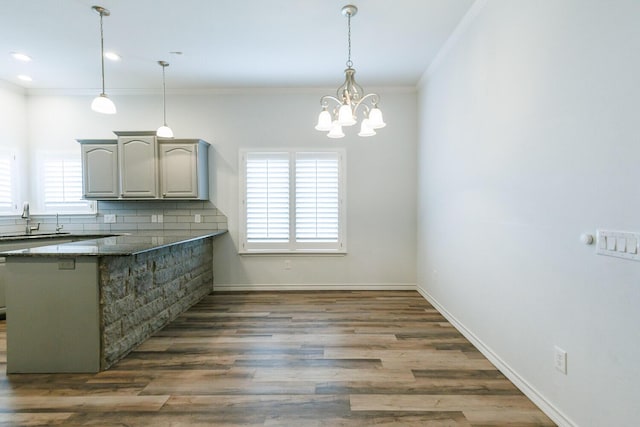 208 Berkshire Ave, Wolfforth, TX 79382 - kitchen featuring a sink, ornamental molding, a peninsula, and a wealth of natural light