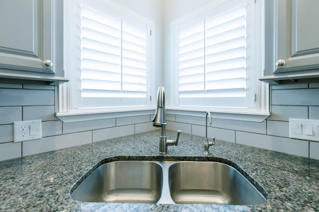208 Berkshire Ave, Wolfforth, TX 79382 - room details with dark stone counters, a sink, and tasteful backsplash