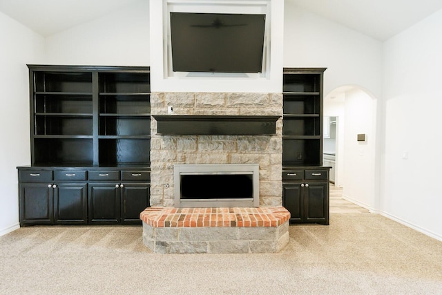 208 Berkshire Ave, Wolfforth, TX 79382 - unfurnished living room with light colored carpet, a fireplace, arched walkways, baseboards, and lofted ceiling