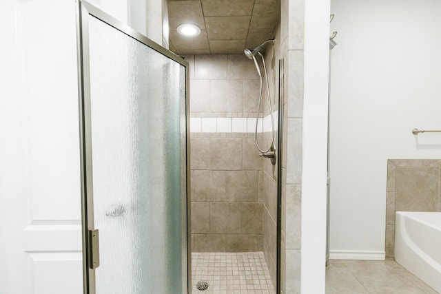 208 Berkshire Ave, Wolfforth, TX 79382 - bathroom with a garden tub, tile patterned floors, and a stall shower