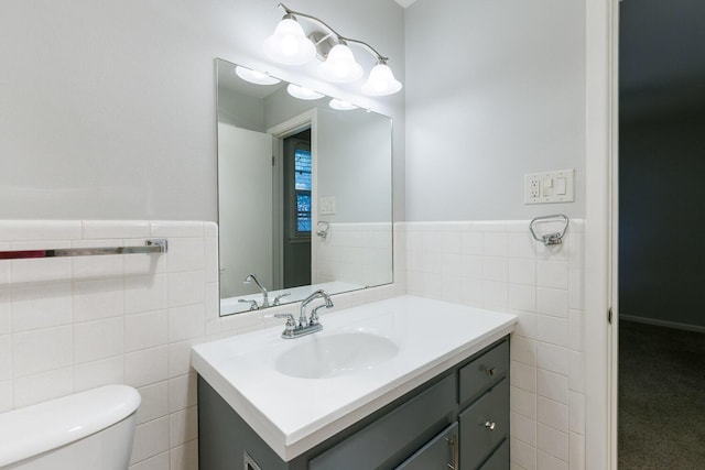 5418 15th St, Lubbock, TX 79416 - half bathroom with tile walls, vanity, and a wainscoted wall