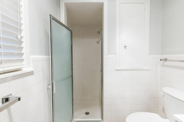 5418 15th St, Lubbock, TX 79416 - full bath with tile walls, a shower stall, and wainscoting
