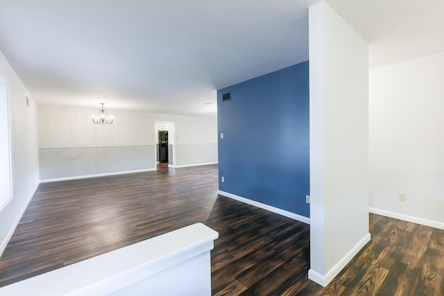 5418 15th St, Lubbock, TX 79416 - unfurnished room featuring a chandelier and dark wood-type flooring