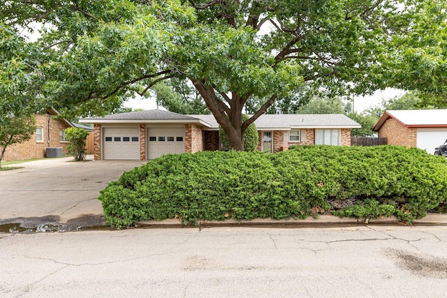 5418 15th St, Lubbock, TX 79416 - ranch-style home featuring driveway, an attached garage, and brick siding