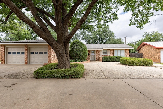 5418 15th St, Lubbock, TX 79416 - view of front facade with driveway, brick siding, and a garage