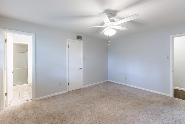 5418 15th St, Lubbock, TX 79416 - unfurnished bedroom with carpet floors, connected bathroom, and a ceiling fan