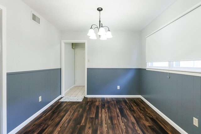 5418 15th St, Lubbock, TX 79416 - unfurnished dining area with a chandelier, wood finished floors, and a wainscoted wall