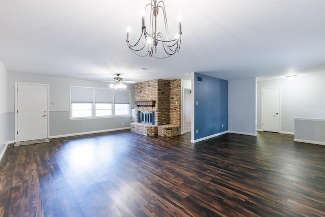 5418 15th St, Lubbock, TX 79416 - unfurnished living room featuring a chandelier, ceiling fan, a fireplace, and dark wood-style flooring