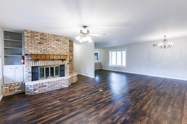 5418 15th St, Lubbock, TX 79416 - unfurnished living room featuring wood finished floors, a chandelier, a fireplace, and ceiling fan