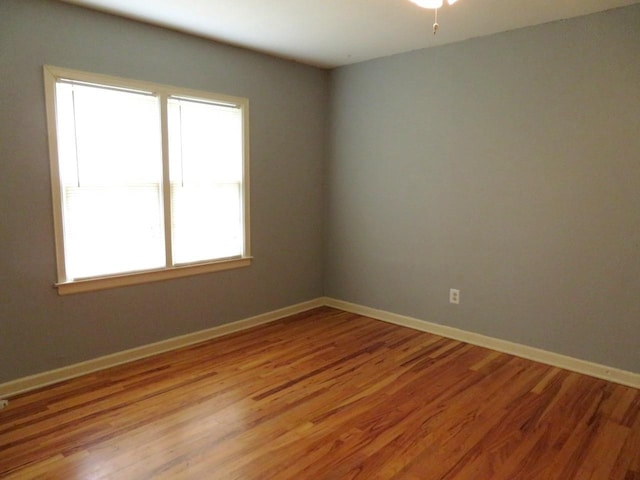 unfurnished room with hardwood / wood-style floors