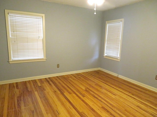 unfurnished room with light wood-type flooring