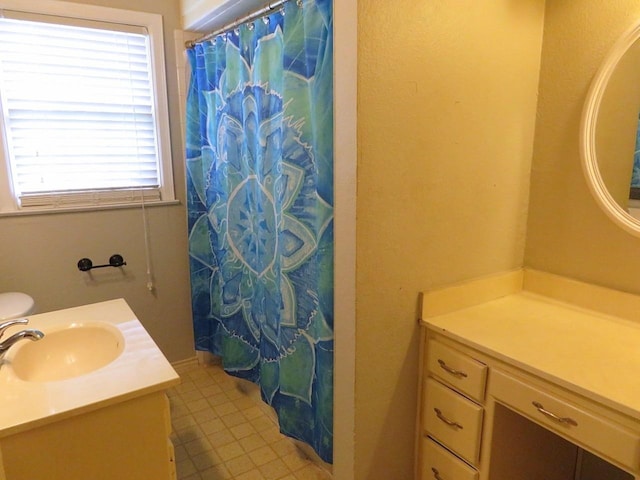 bathroom with vanity, tile patterned flooring, curtained shower, and a healthy amount of sunlight