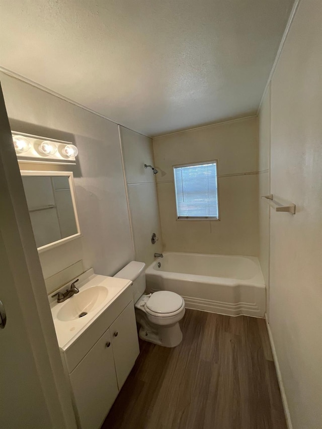 full bathroom with shower / bathing tub combination, wood-type flooring, vanity, toilet, and a textured ceiling