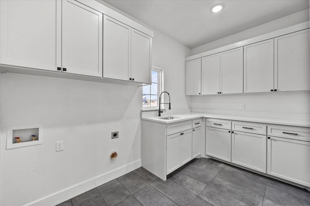 laundry area featuring cabinets, hookup for a washing machine, sink, and electric dryer hookup