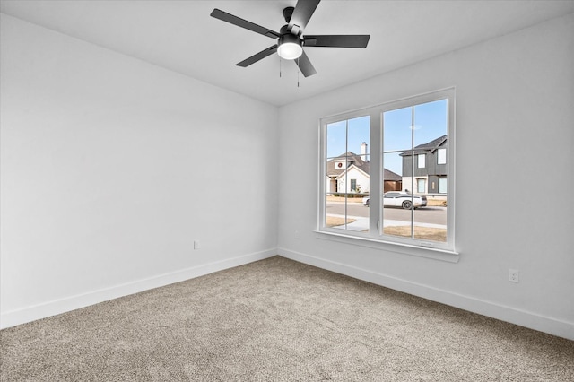 unfurnished room featuring ceiling fan and carpet floors